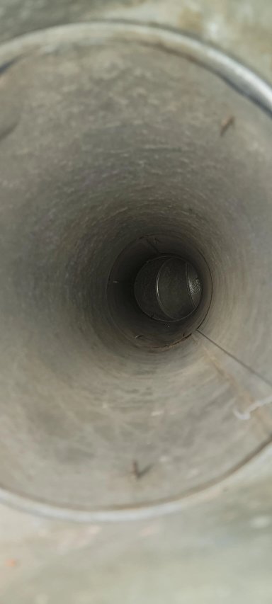 Inside view of a cylindrical pipe highlighting texture and depth.