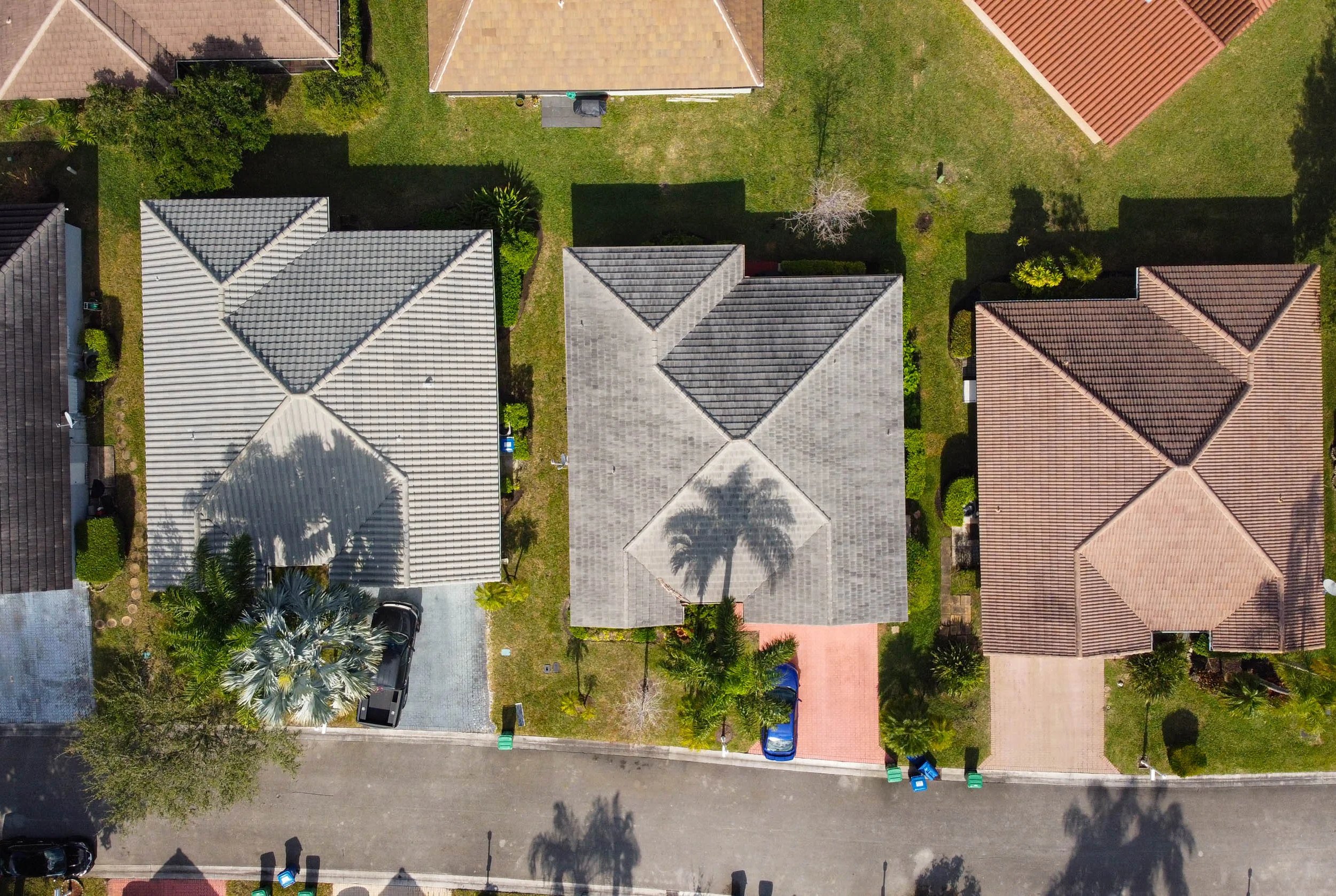Aerial view of suburban houses with varying roof styles.
