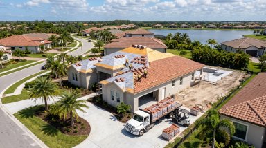 Construction workers installing a new roof on a house.