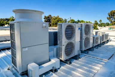 Commercial rooftop HVAC units under a clear blue sky