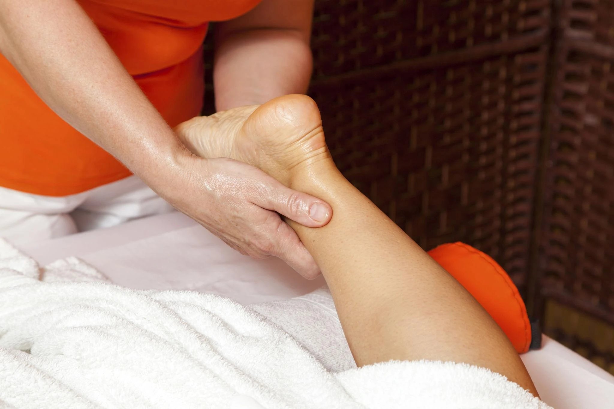 A person receiving a foot massage in a spa setting.