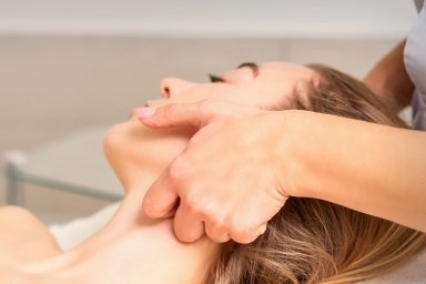 Massage therapist performing a neck and shoulder massage