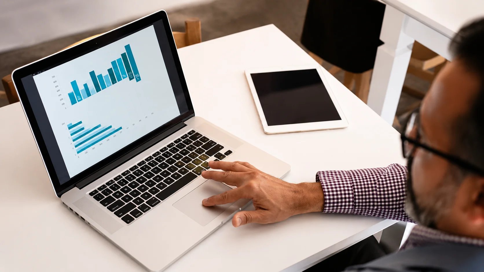 Business professional analyzing data on a laptop