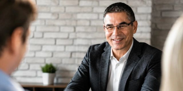 Professional man smiling during a business meeting