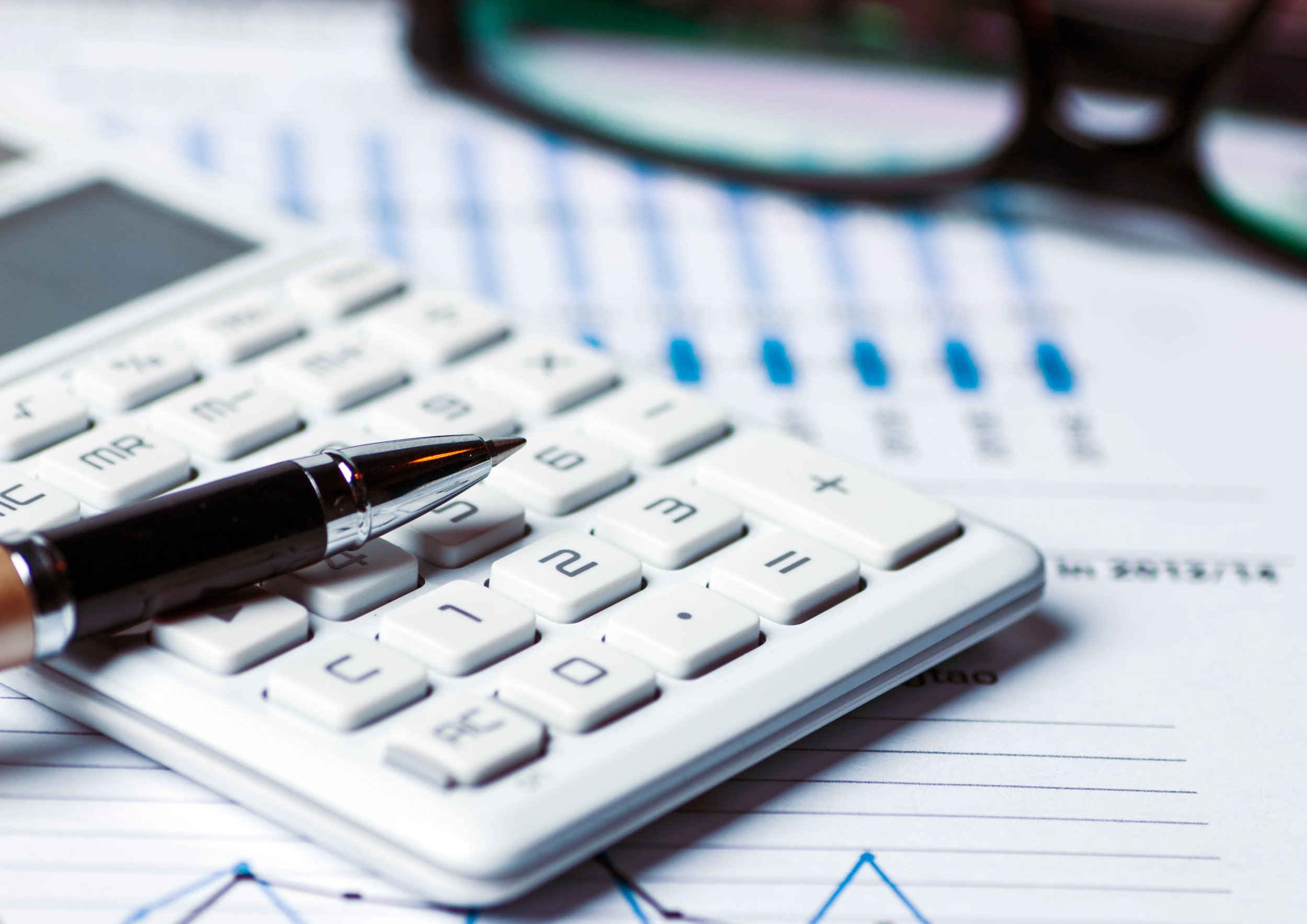 Calculator and pen on financial documents