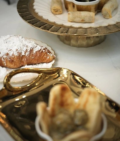 Elegant dessert platter with croissant and pastries.