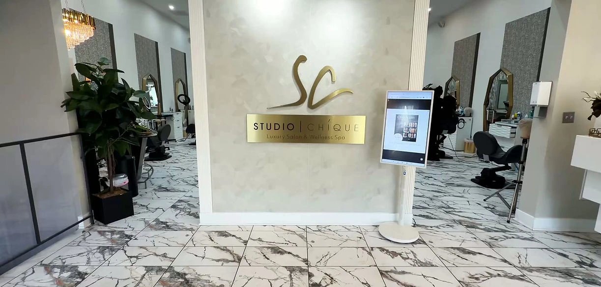 Interior view of Studio Chicque, a luxury beauty spa with marble flooring and elegant decor.