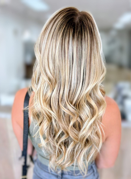 Woman with long blonde hair styled in waves