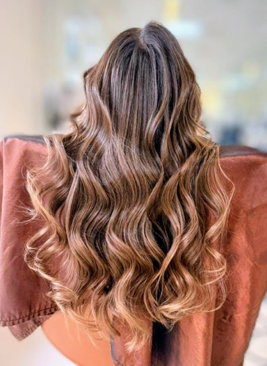 Woman with long, wavy hair viewed from the back