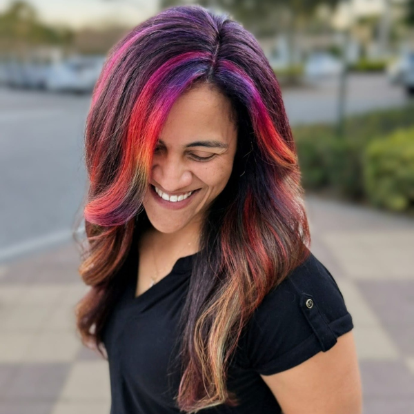 Smiling woman with vibrant multi-colored hair