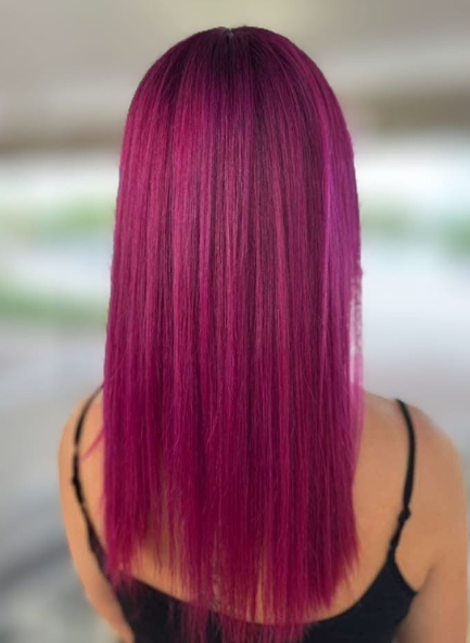 Person with vibrant pink hair seen from the back.