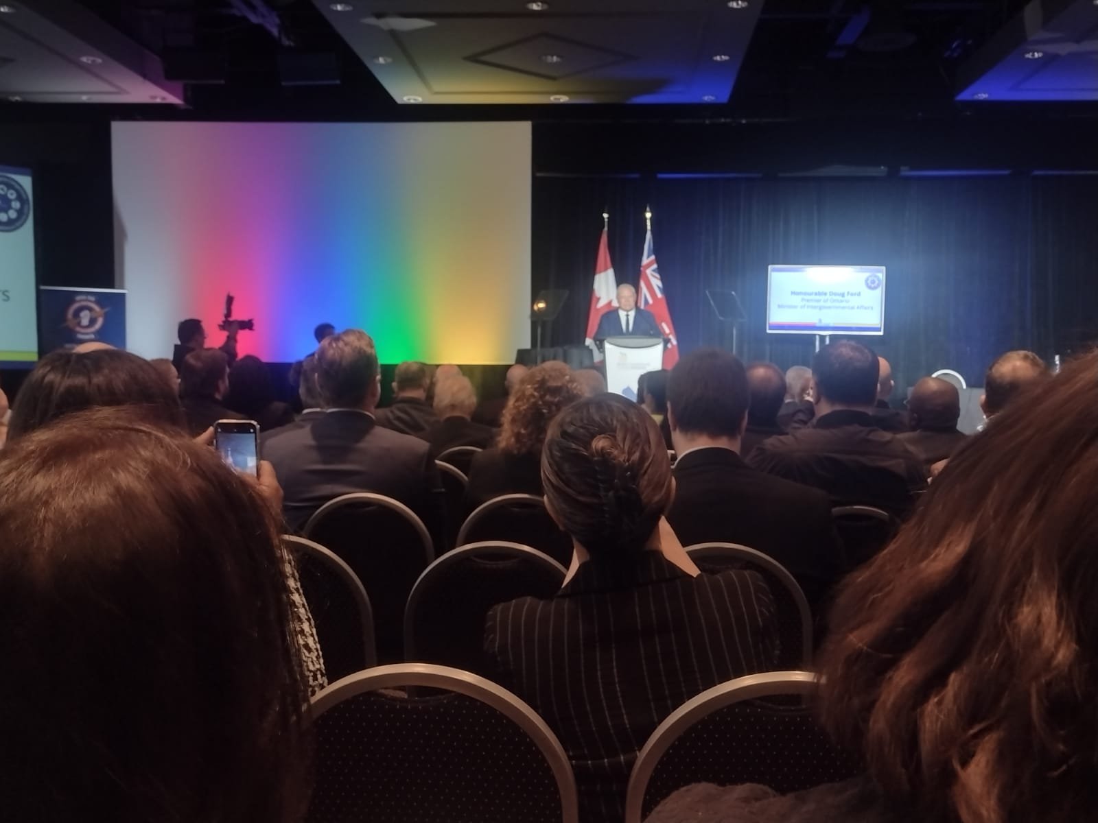 Conference event with speakers at a podium and audience