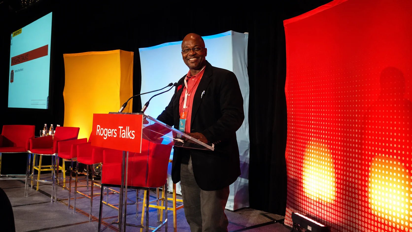 A speaker at a conference giving a presentation.