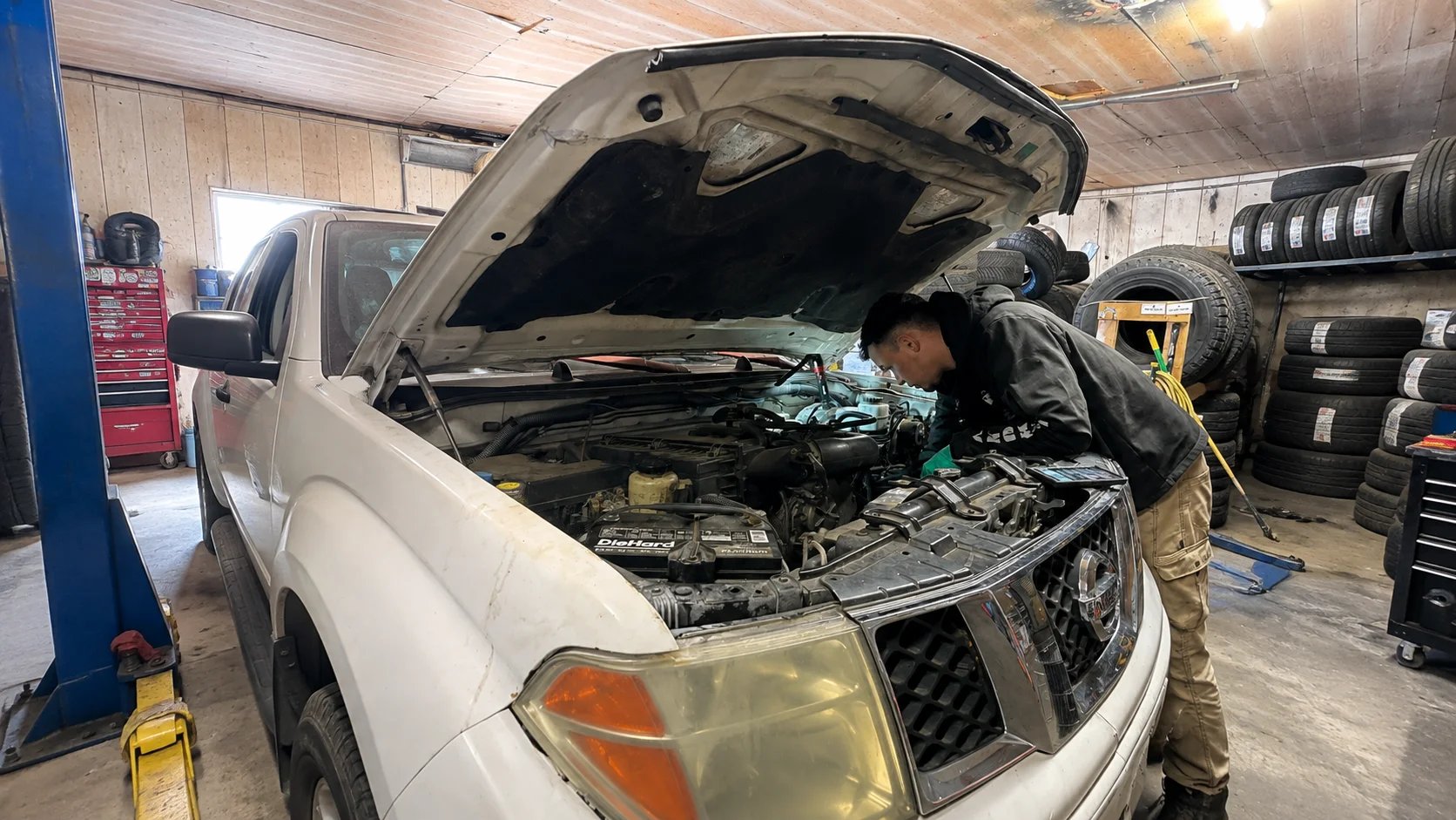 Mechanic working under the hood of a vehicle