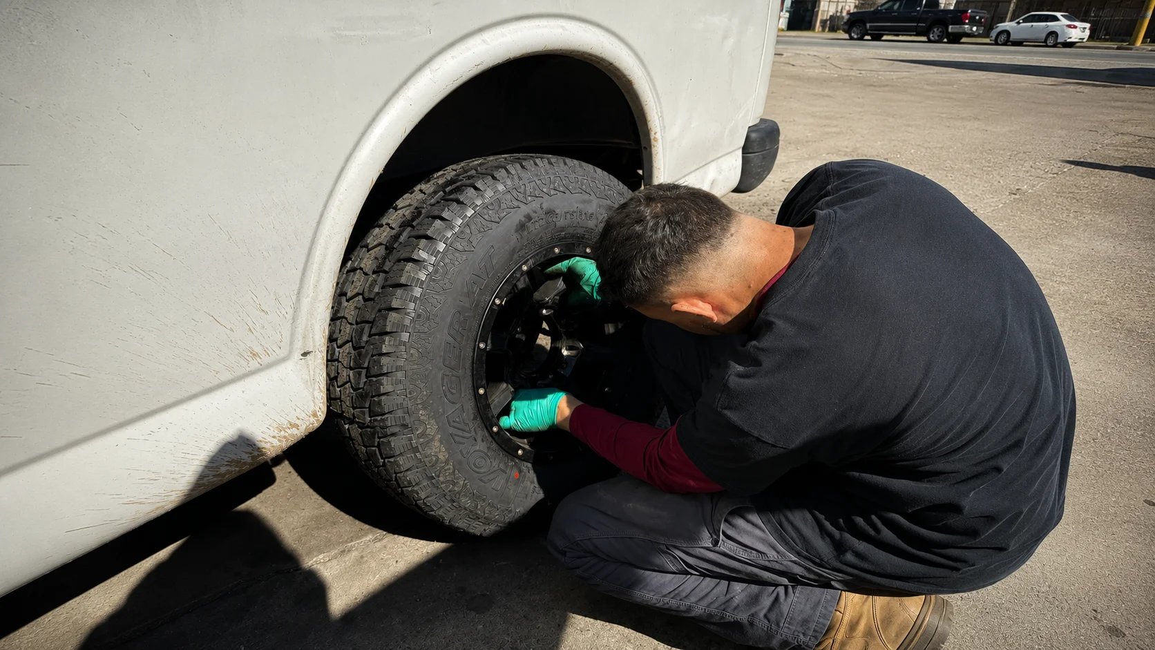 Mechanic changing a tire on a van
