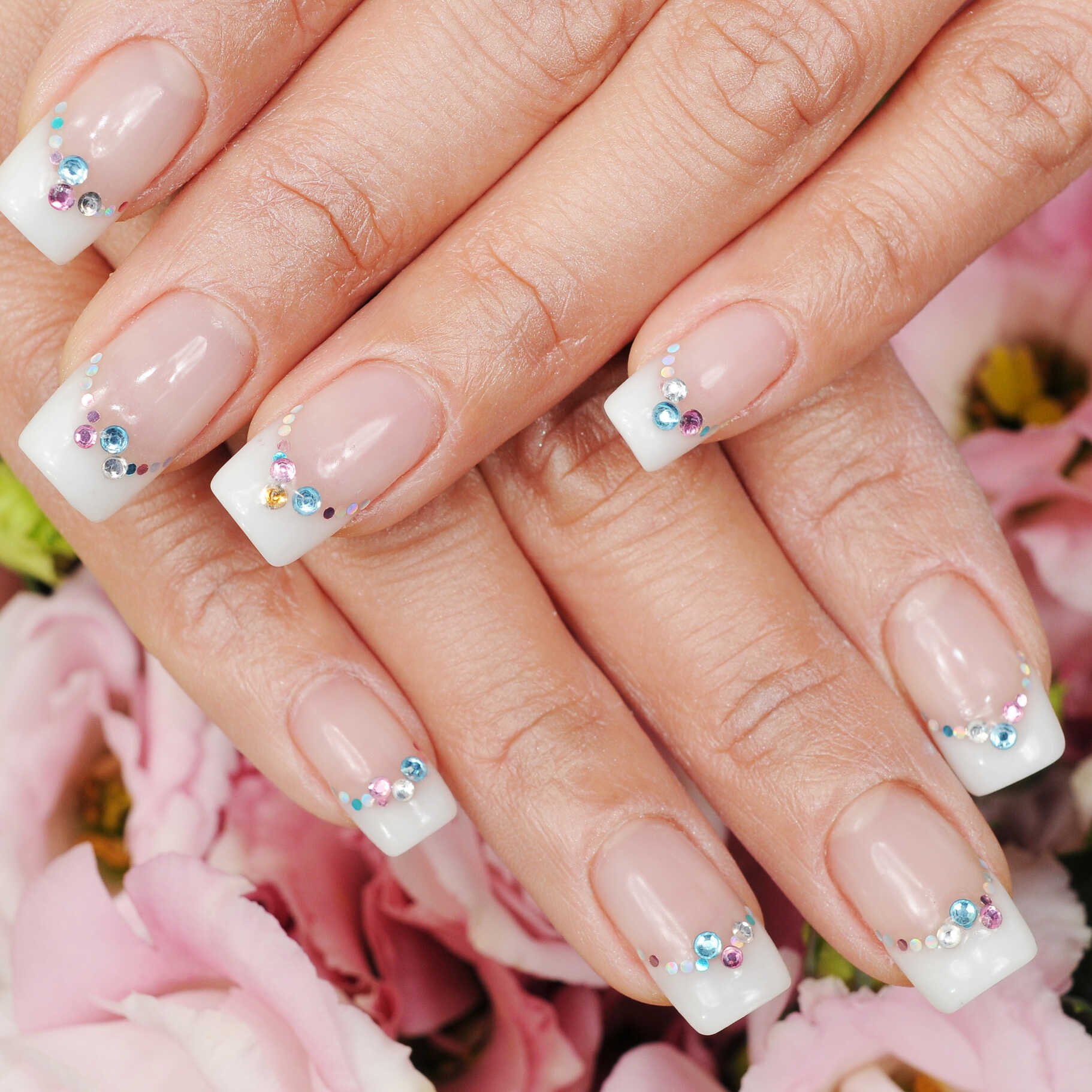 Elegant manicure with colorful rhinestones on nails