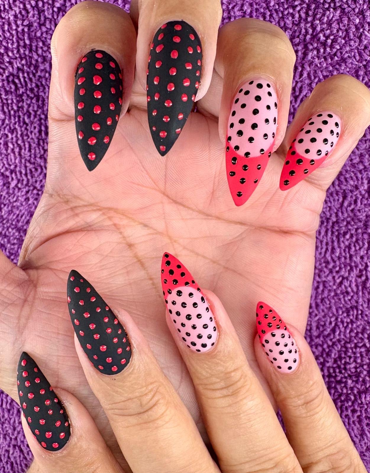 Artistic nail design showcasing polka dots and color contrast.