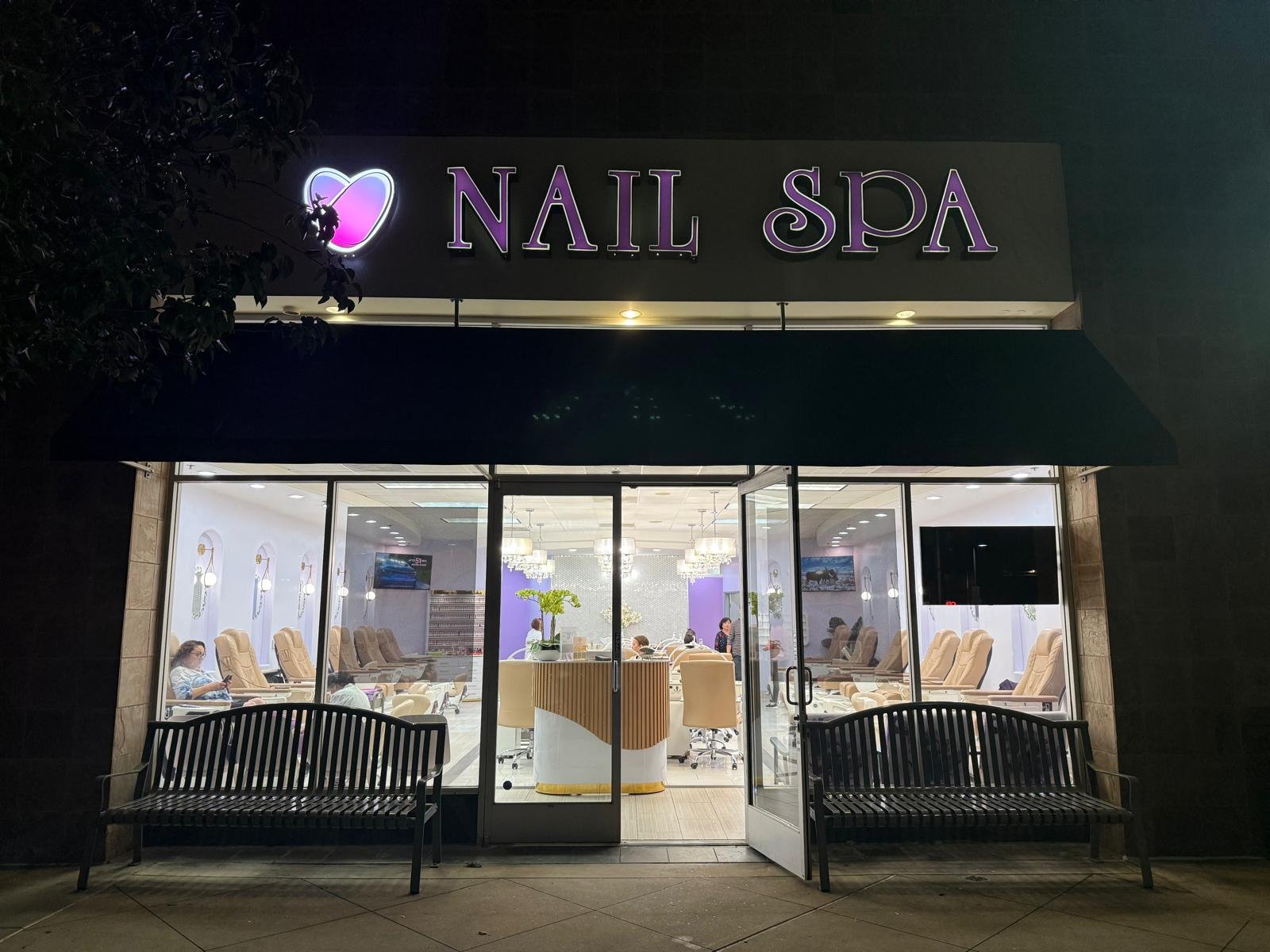 Exterior view of a Nail Spa with illuminated signage at night
