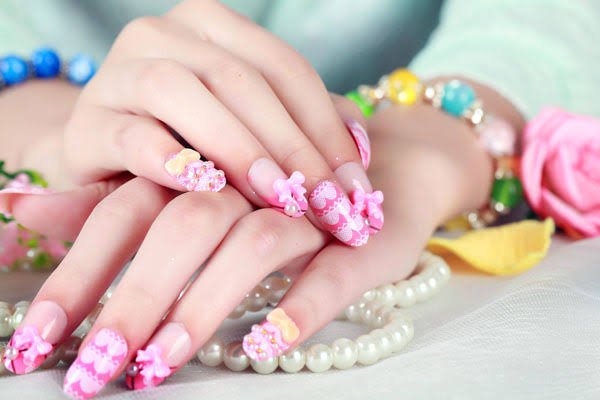 Close-up of hands with nail art and accessories