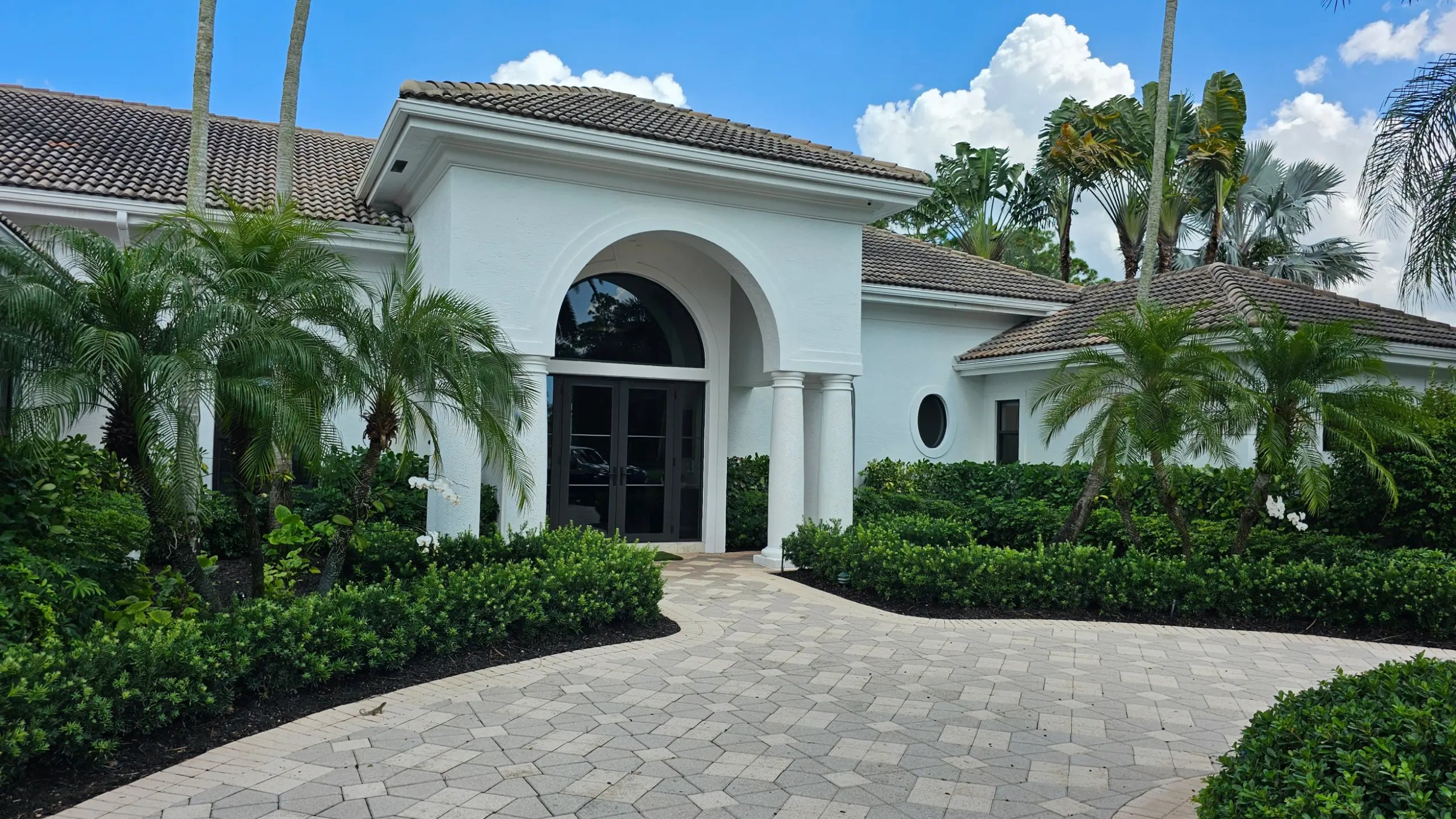 Elegant white house entrance with landscaping