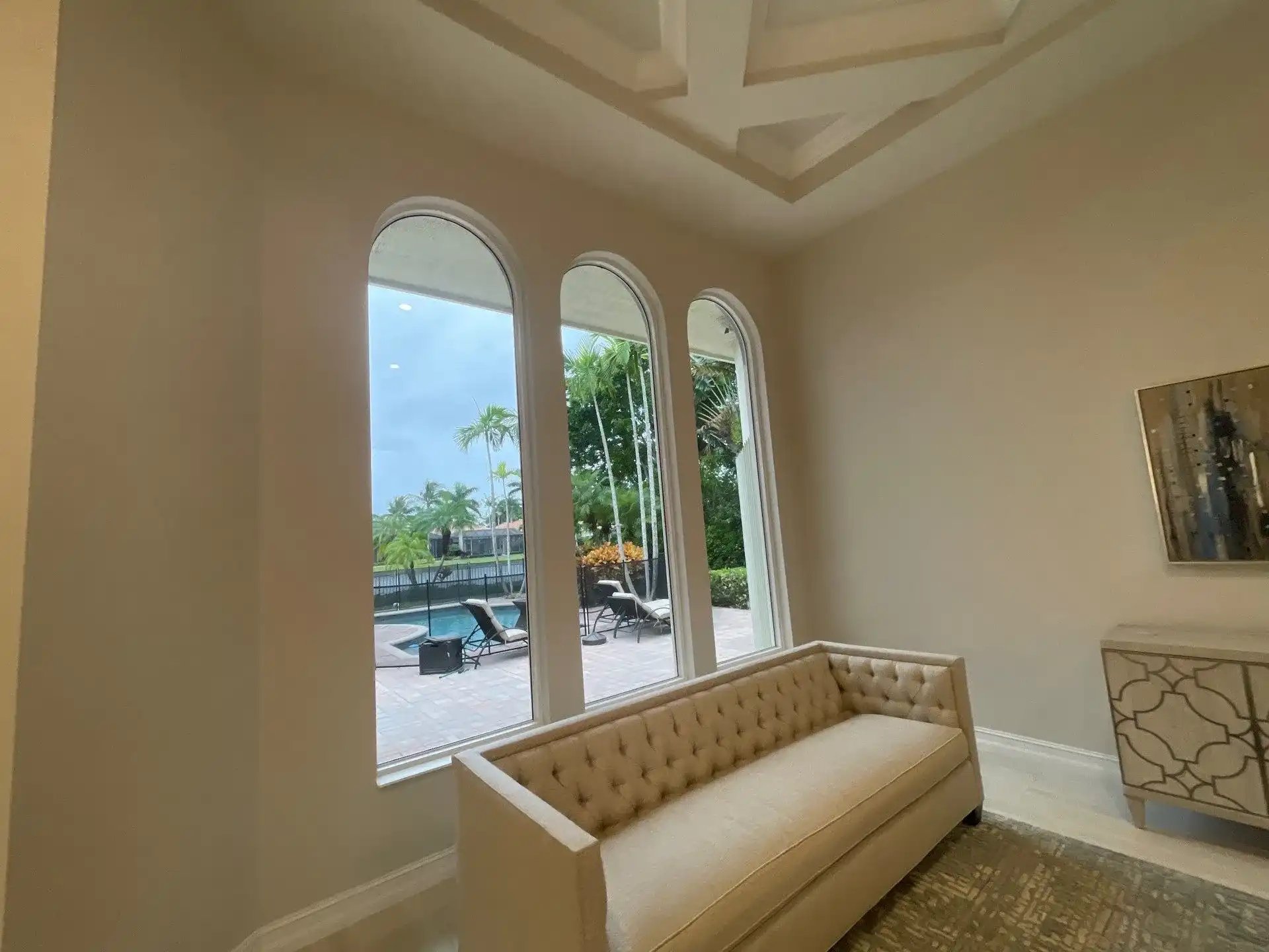 Elegantly designed interior with a view of a poolside garden.