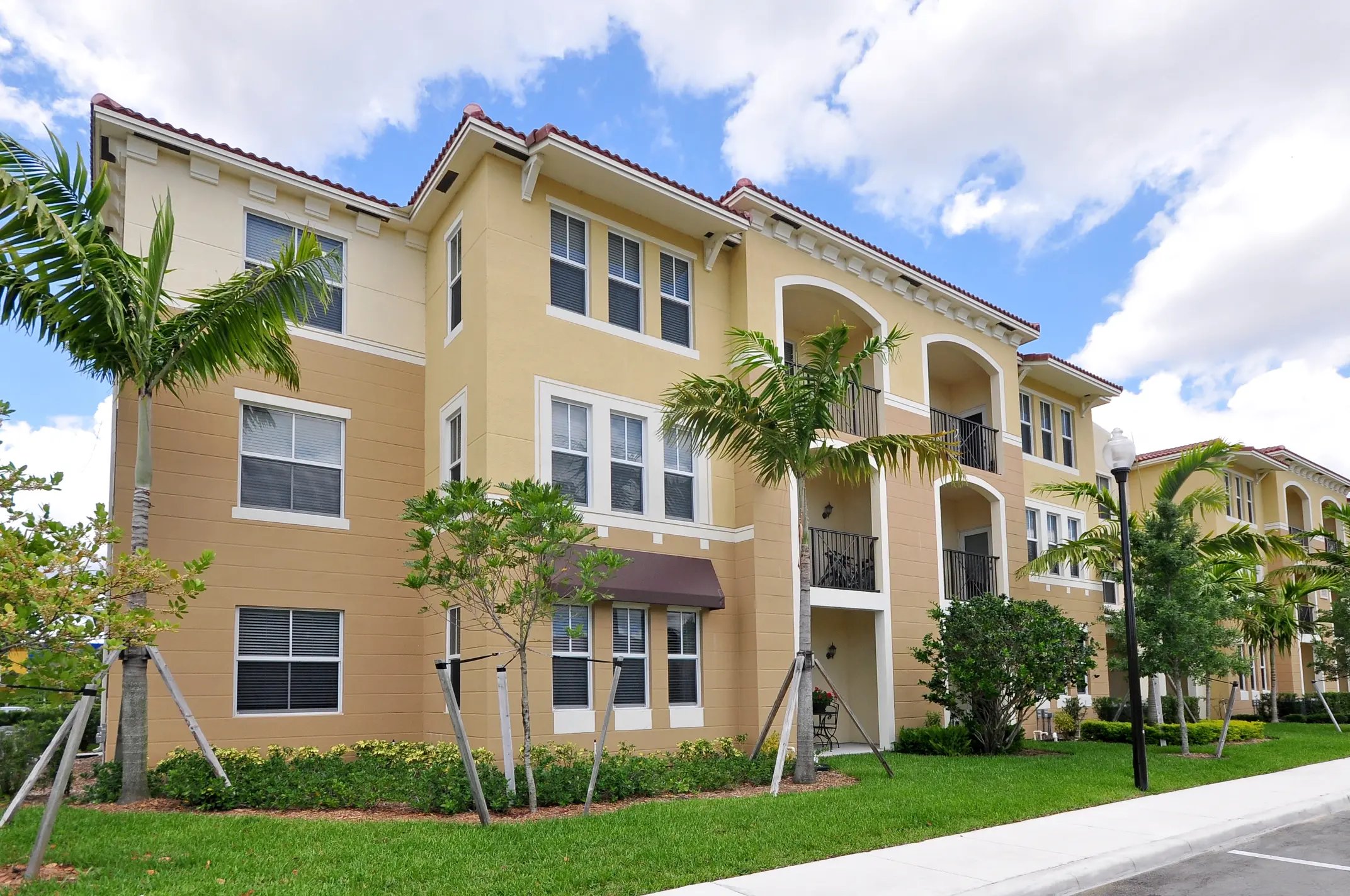 Modern apartment building with palm trees