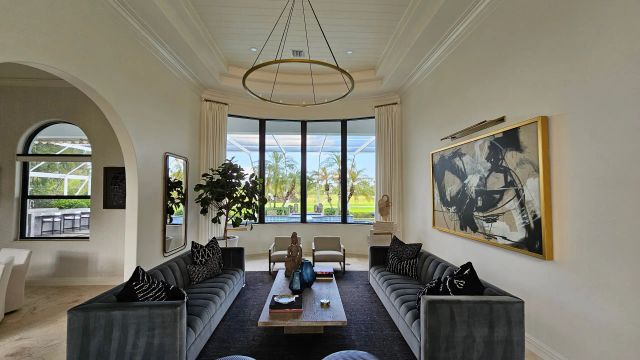 Modern living room with large windows and plush sofas