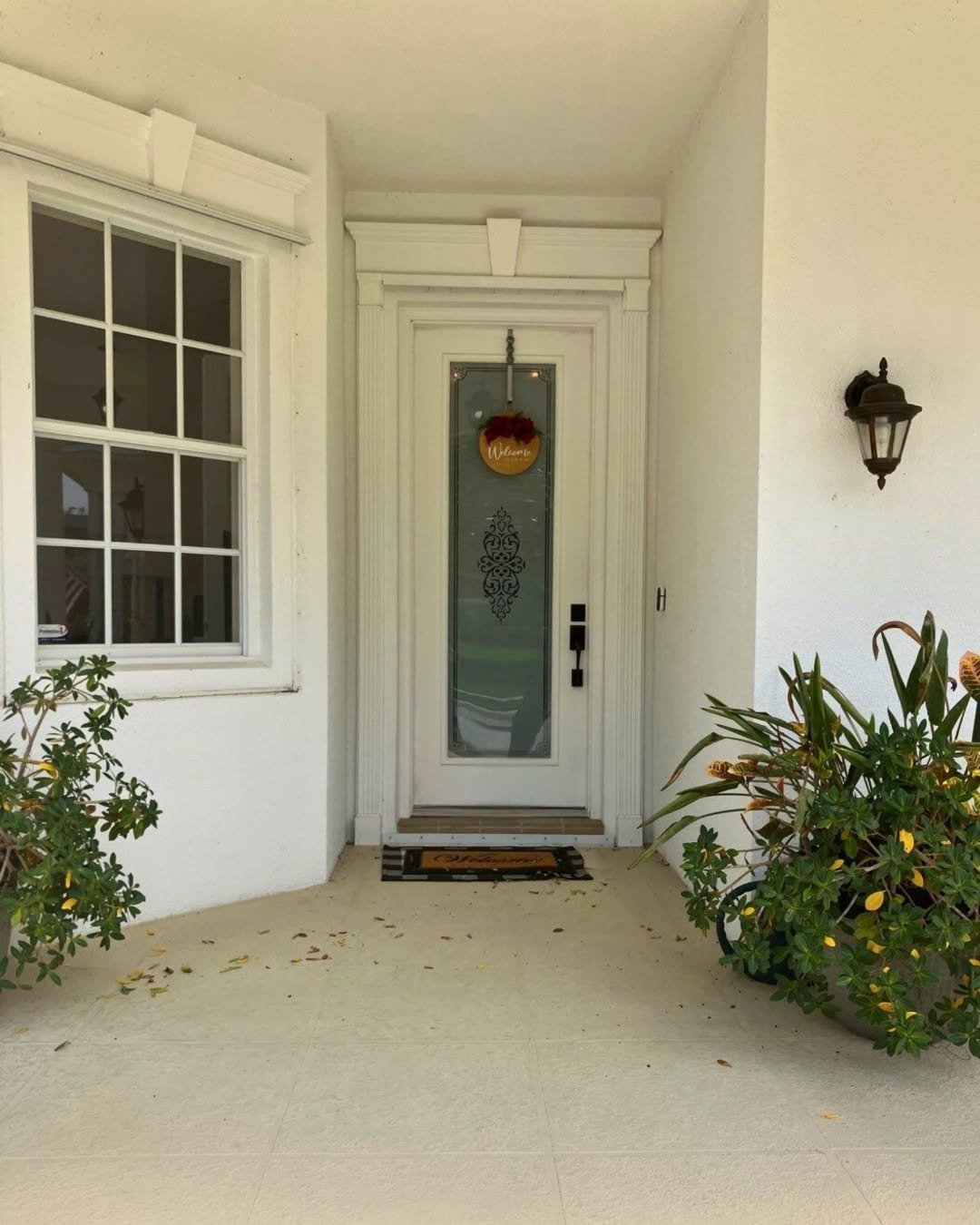Welcoming front door entrance with greenery