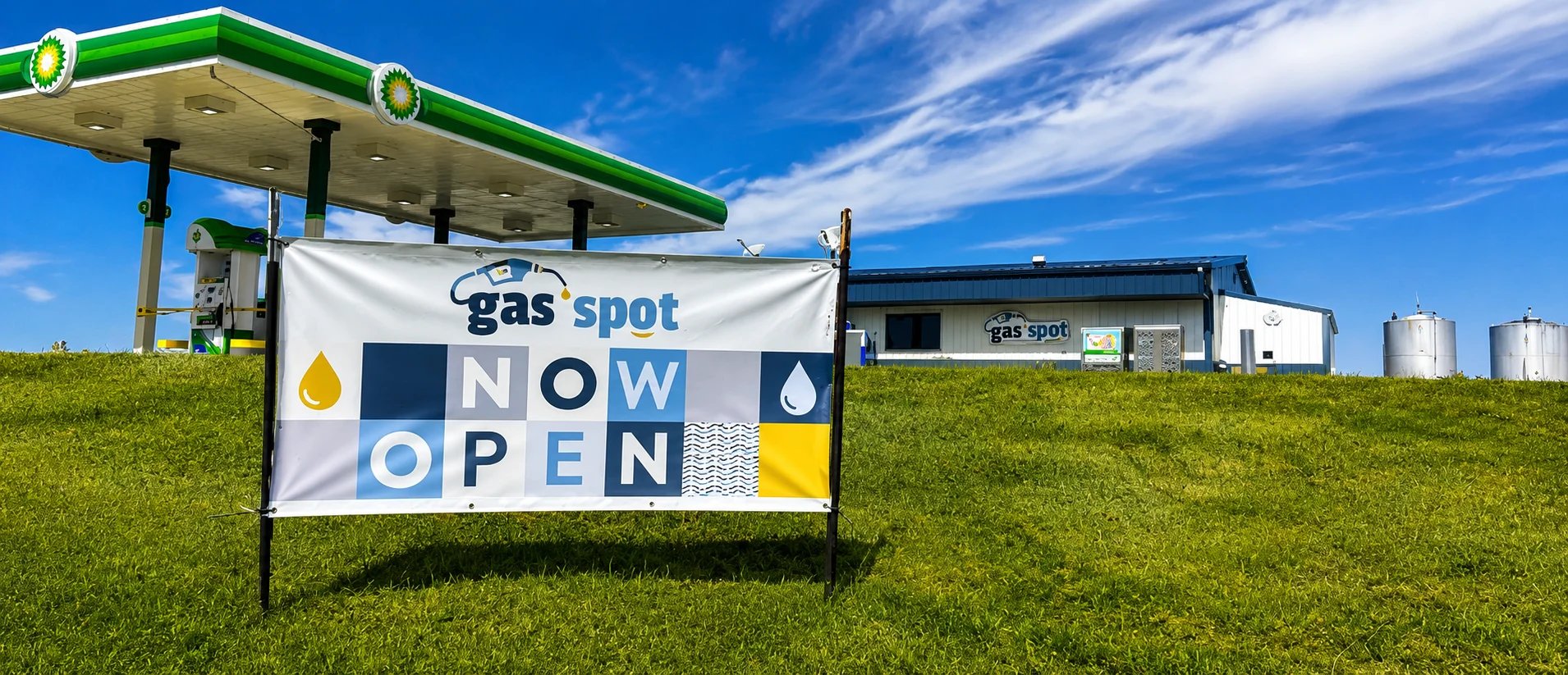 Gas station with a new opening sign, blue skies