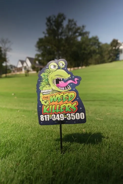 A colorful lawn sign promoting weed killer services