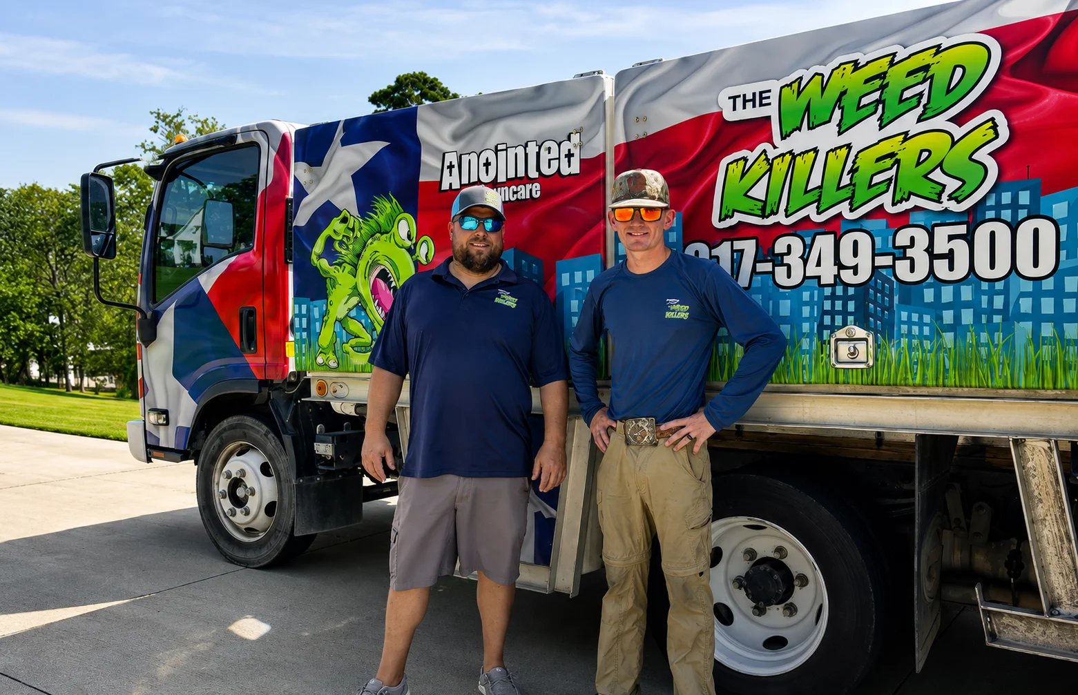Two professionals standing by a branded lawn care truck