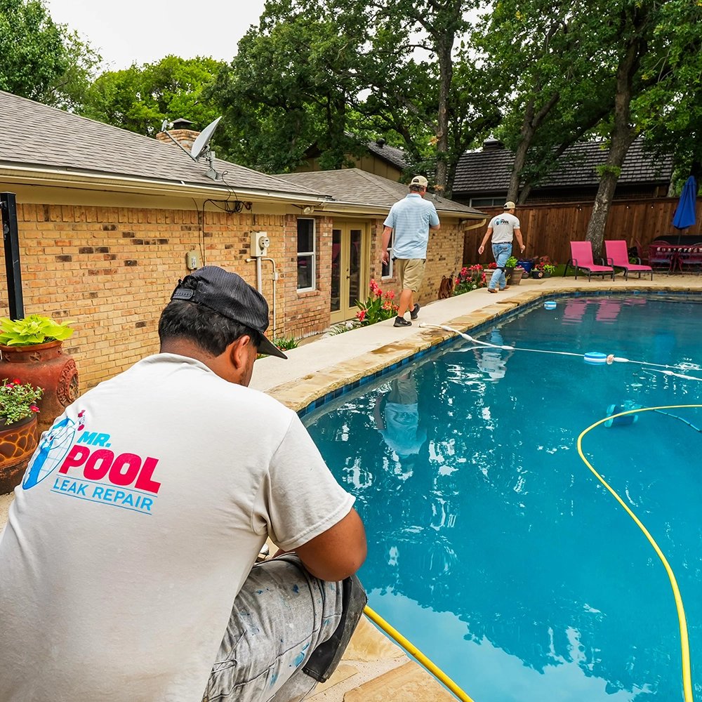 Pool leak repair service in action with technicians