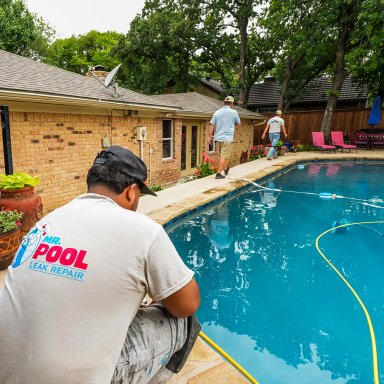 Pool leak repair service in action with technicians