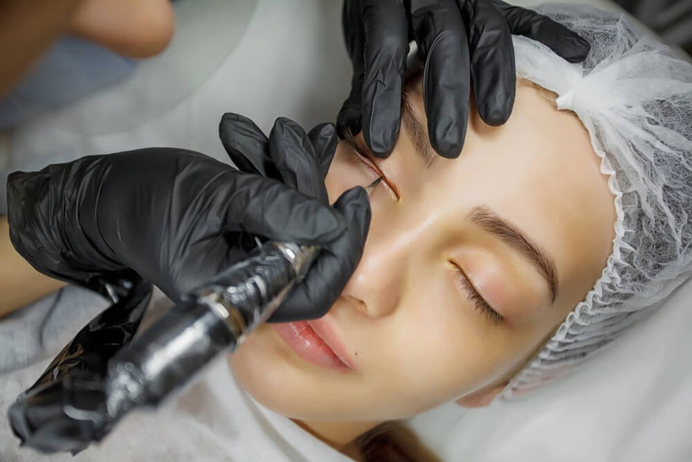 Person receiving cosmetic tattoo procedure on eyelids