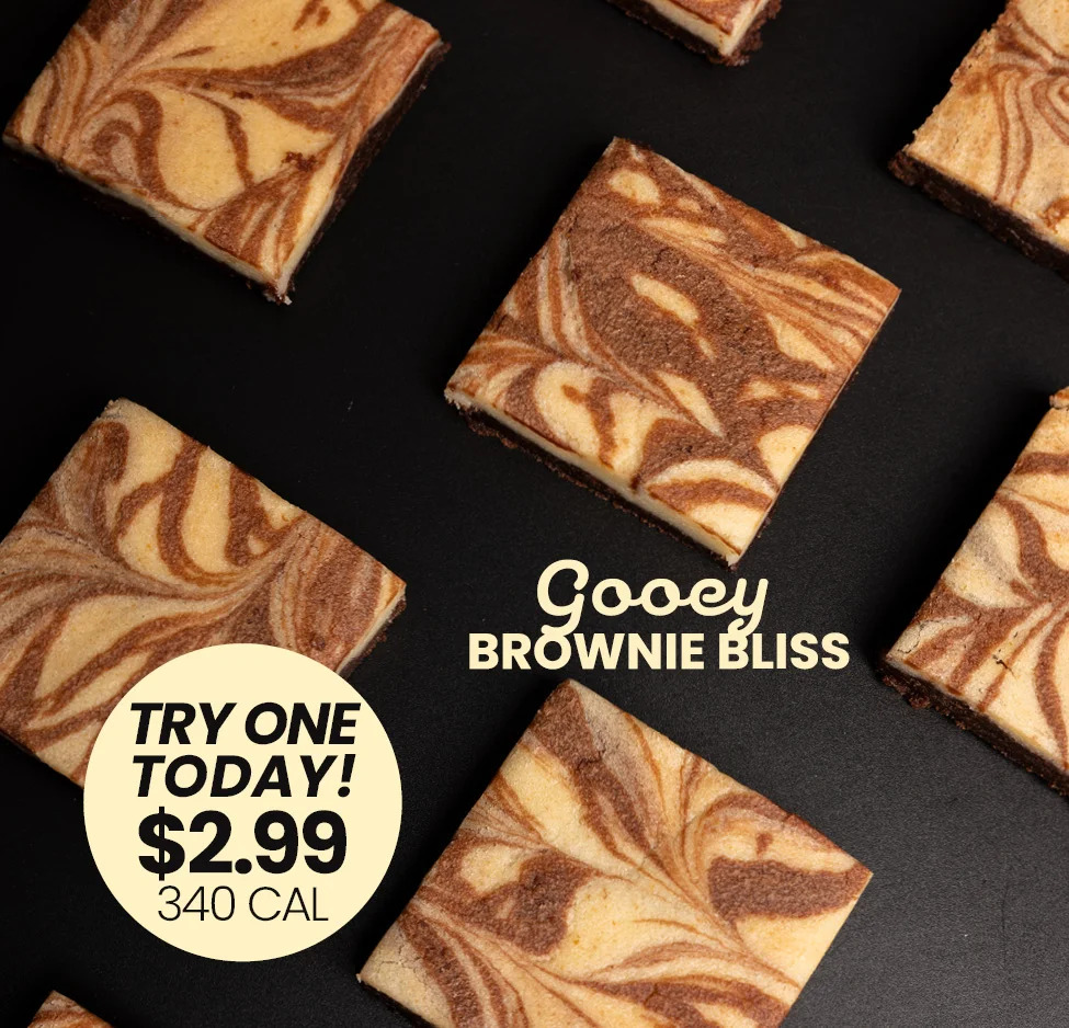 Gooey brownie bliss squares arranged on a black surface.