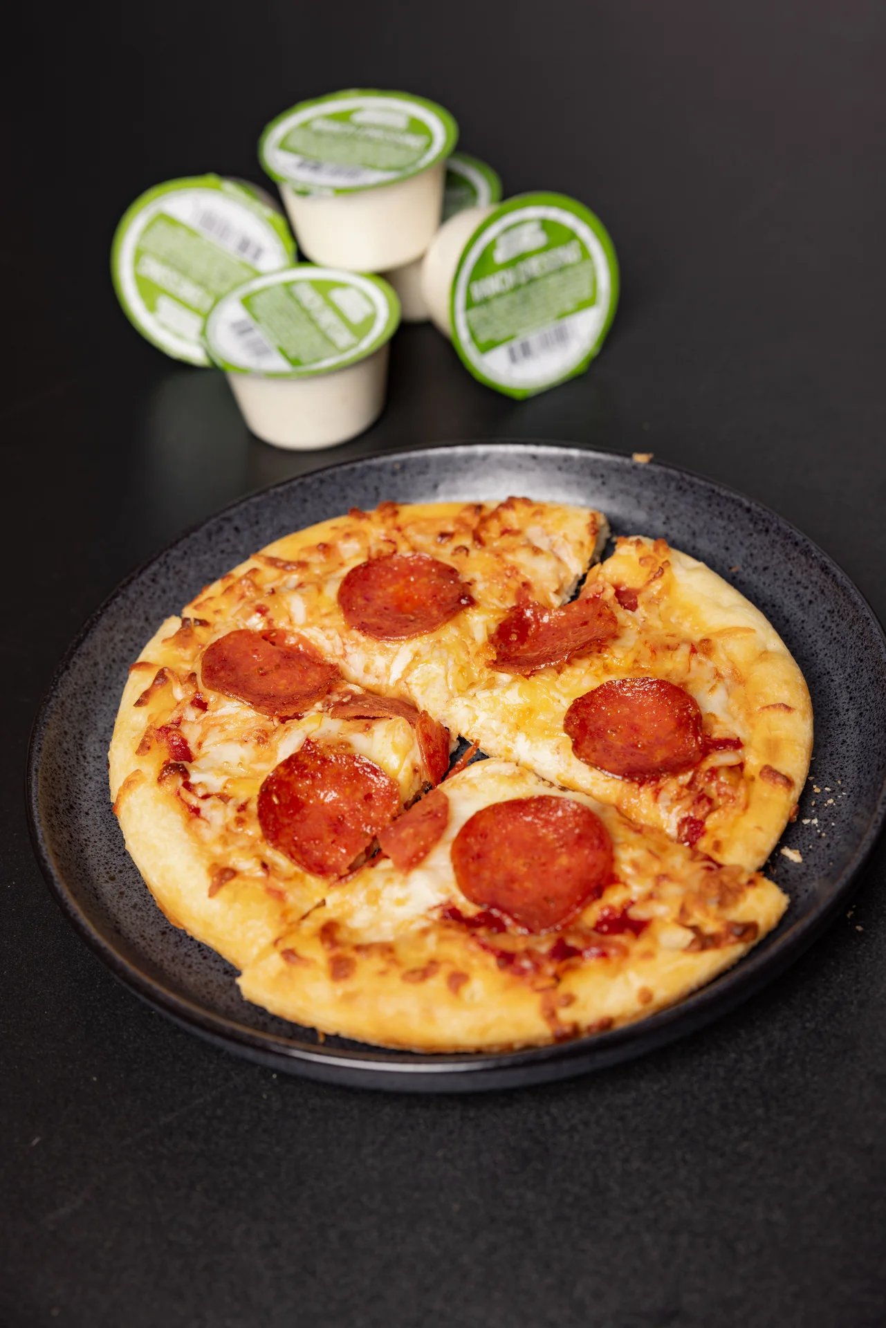 Delicious pepperoni pizza with dipping sauces