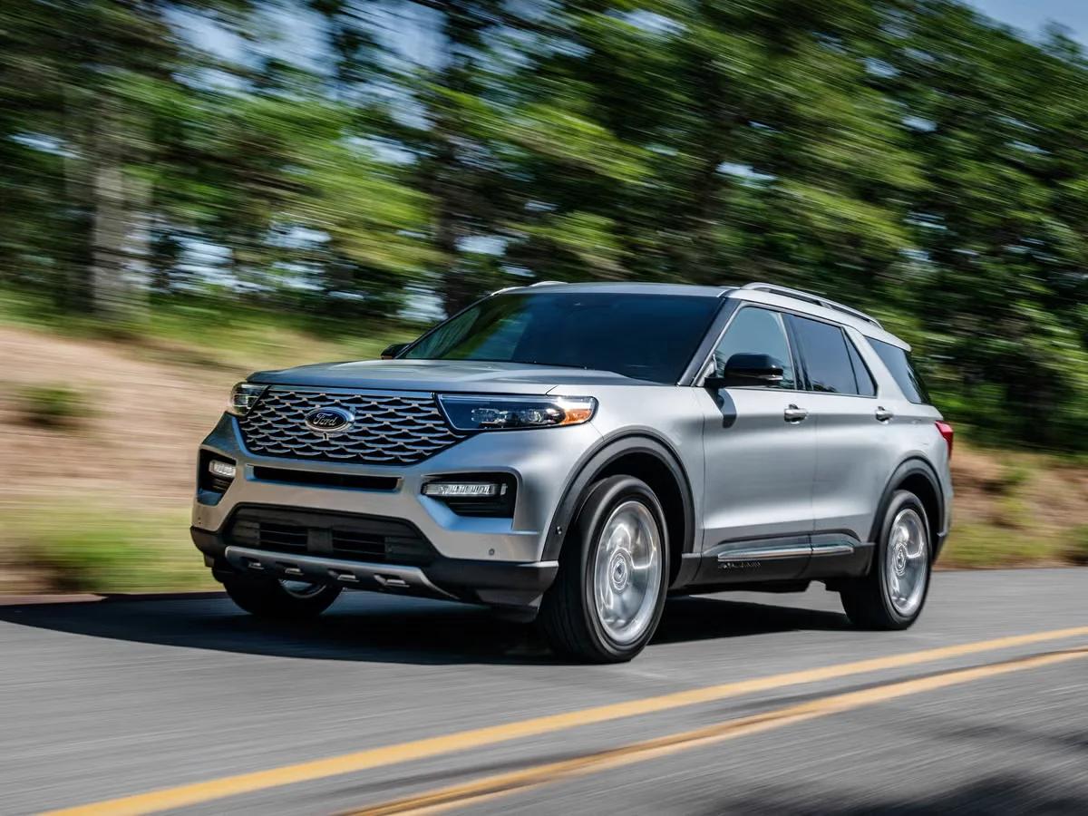 Silver SUV in motion on a forested road