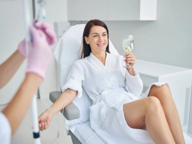 Woman receiving IV therapy with lemon water