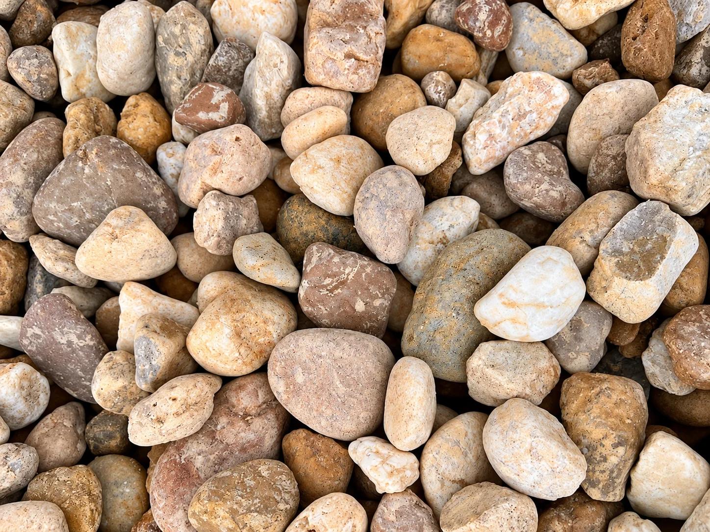 A collection of smooth, rounded stones in various shades of brown and beige