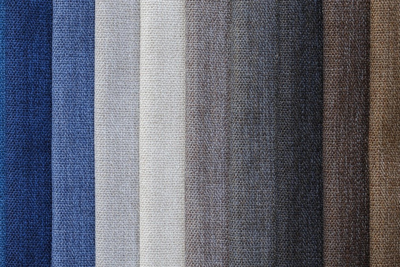 Textiles in various shades arranged vertically
