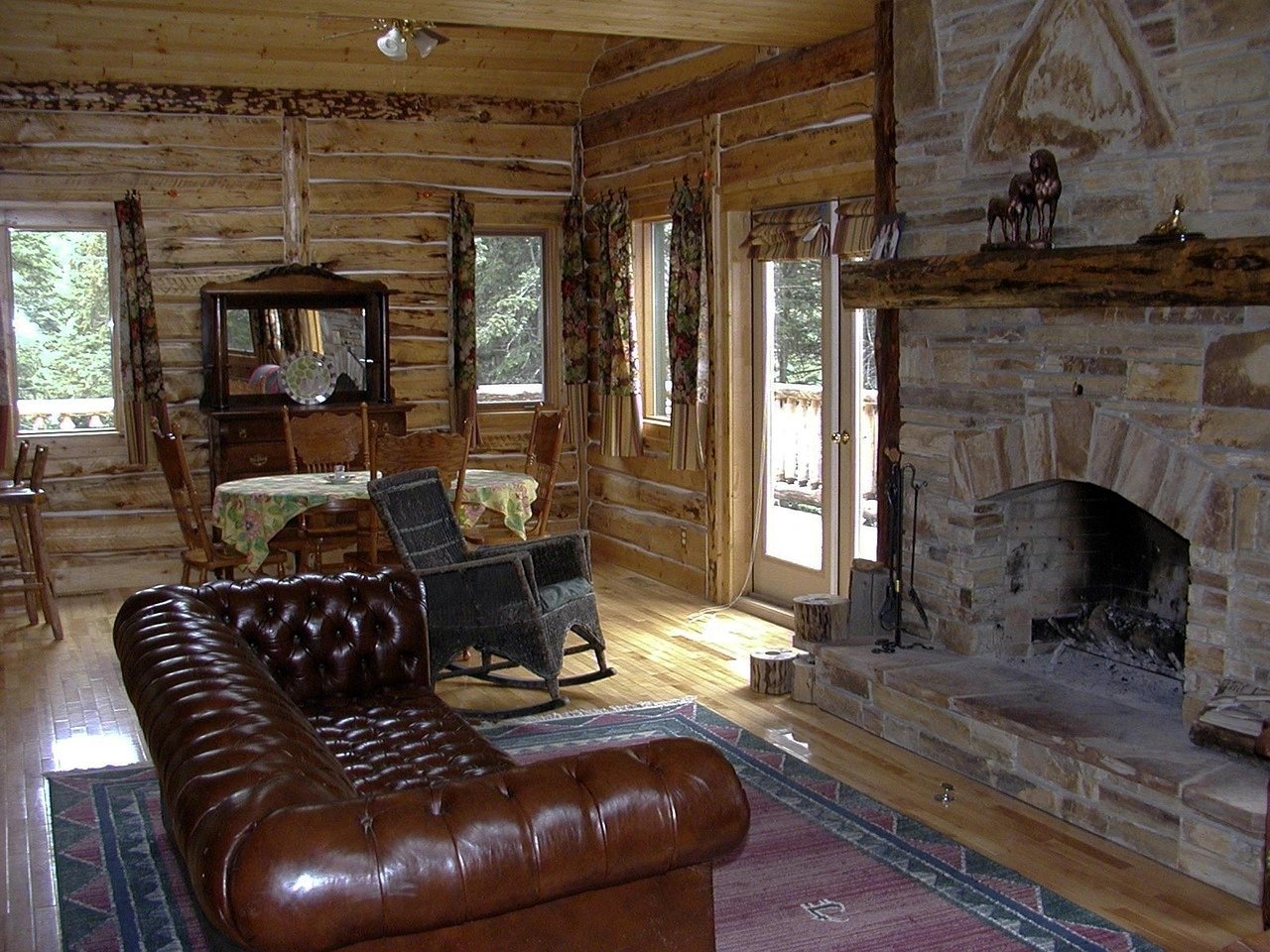 Rustic log cabin living room with fireplace and furniture