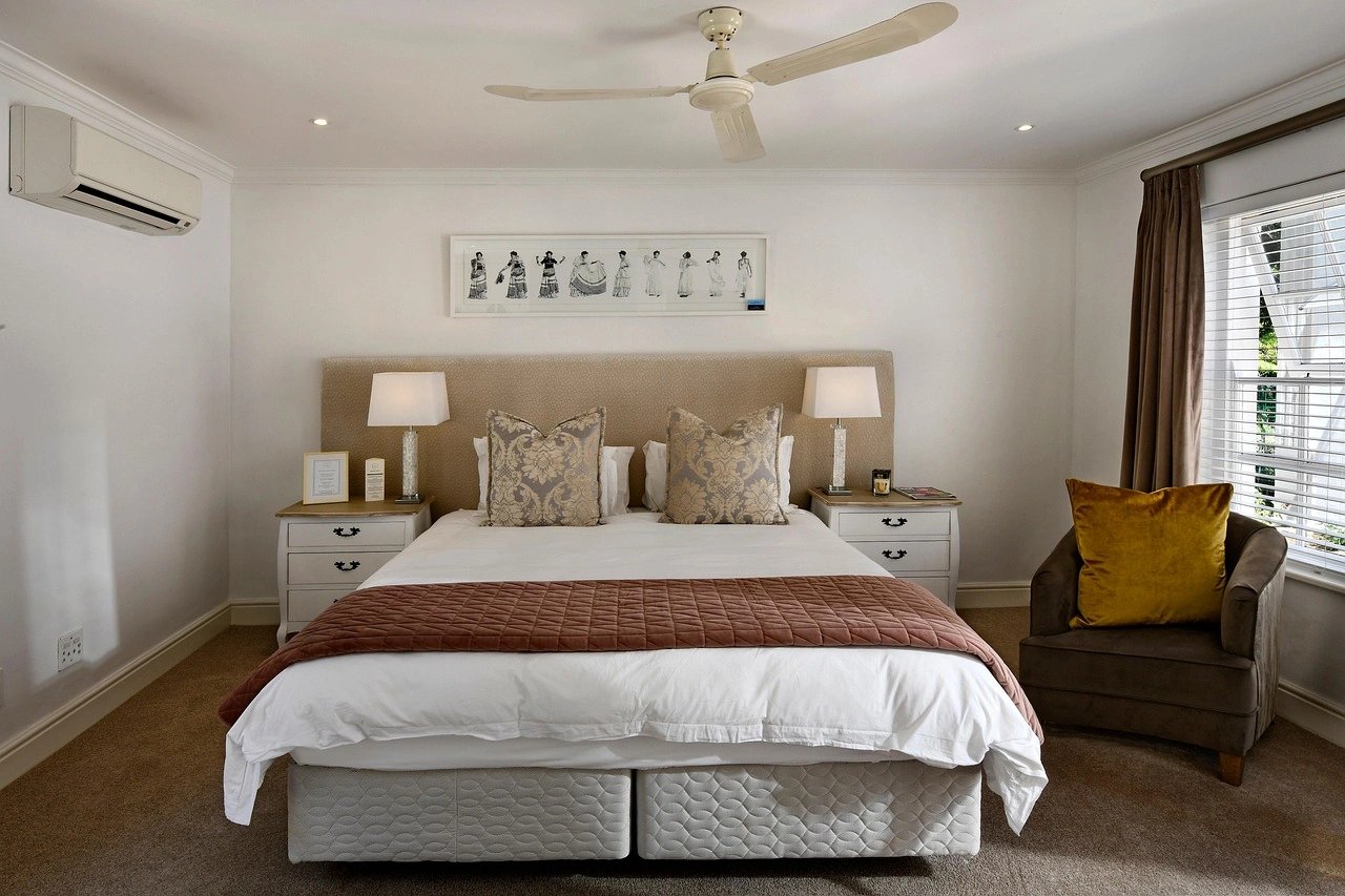 Elegant bedroom with a king-size bed and modern decor.