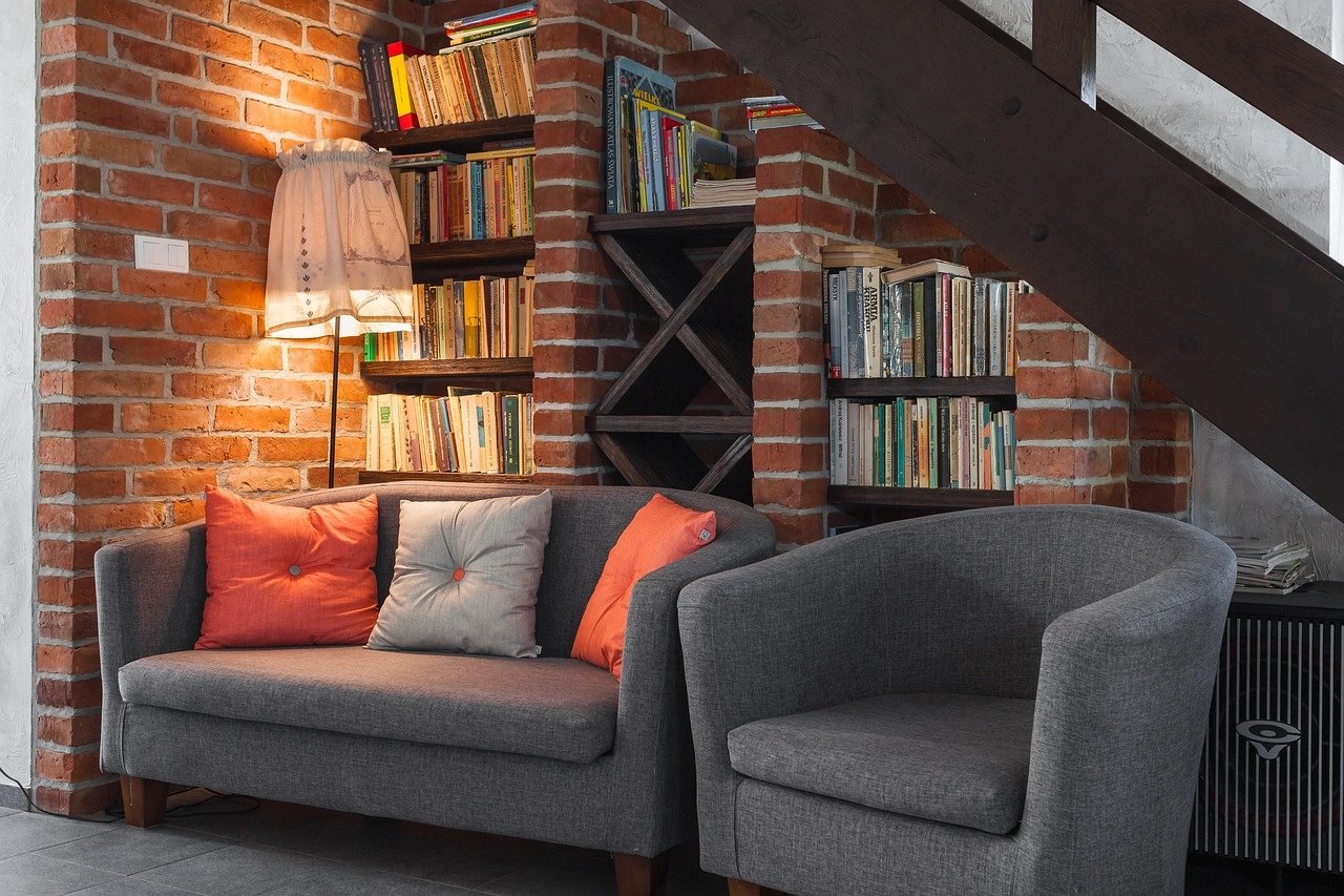Cozy living room with gray sofa and bookshelves