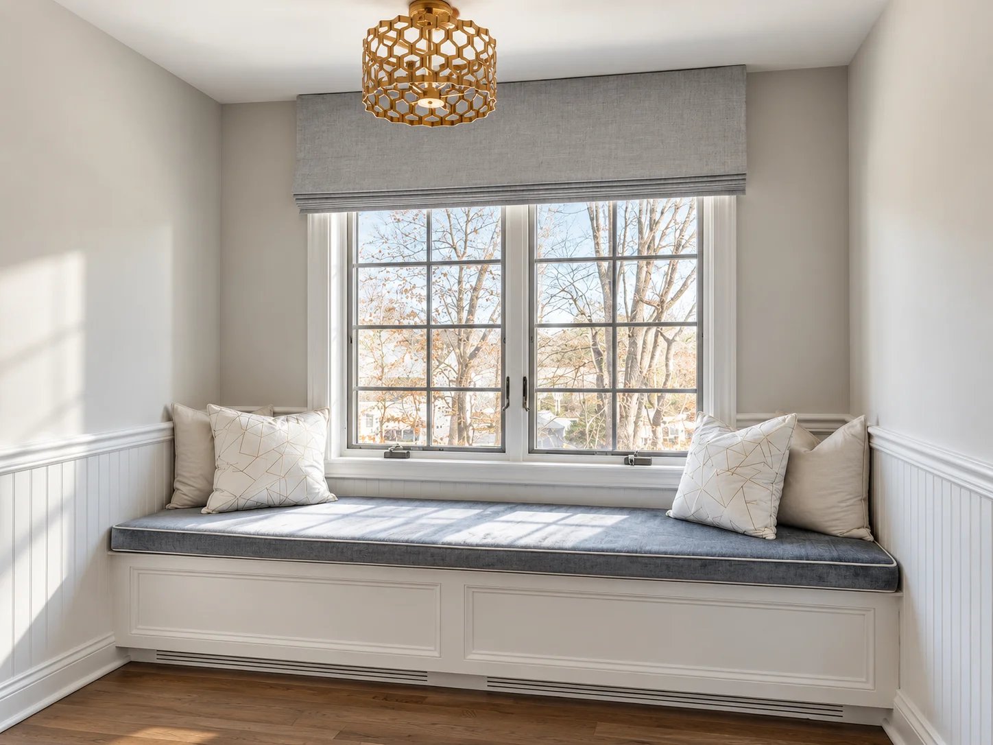 Cozy window seat with pillows and natural light.