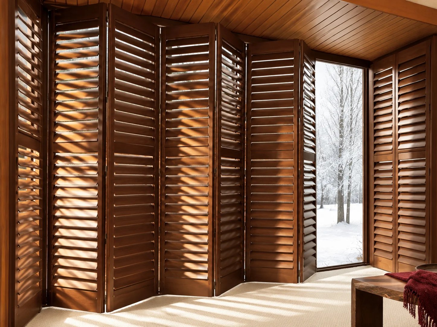 Wooden shutters in a sunlit room with winter view