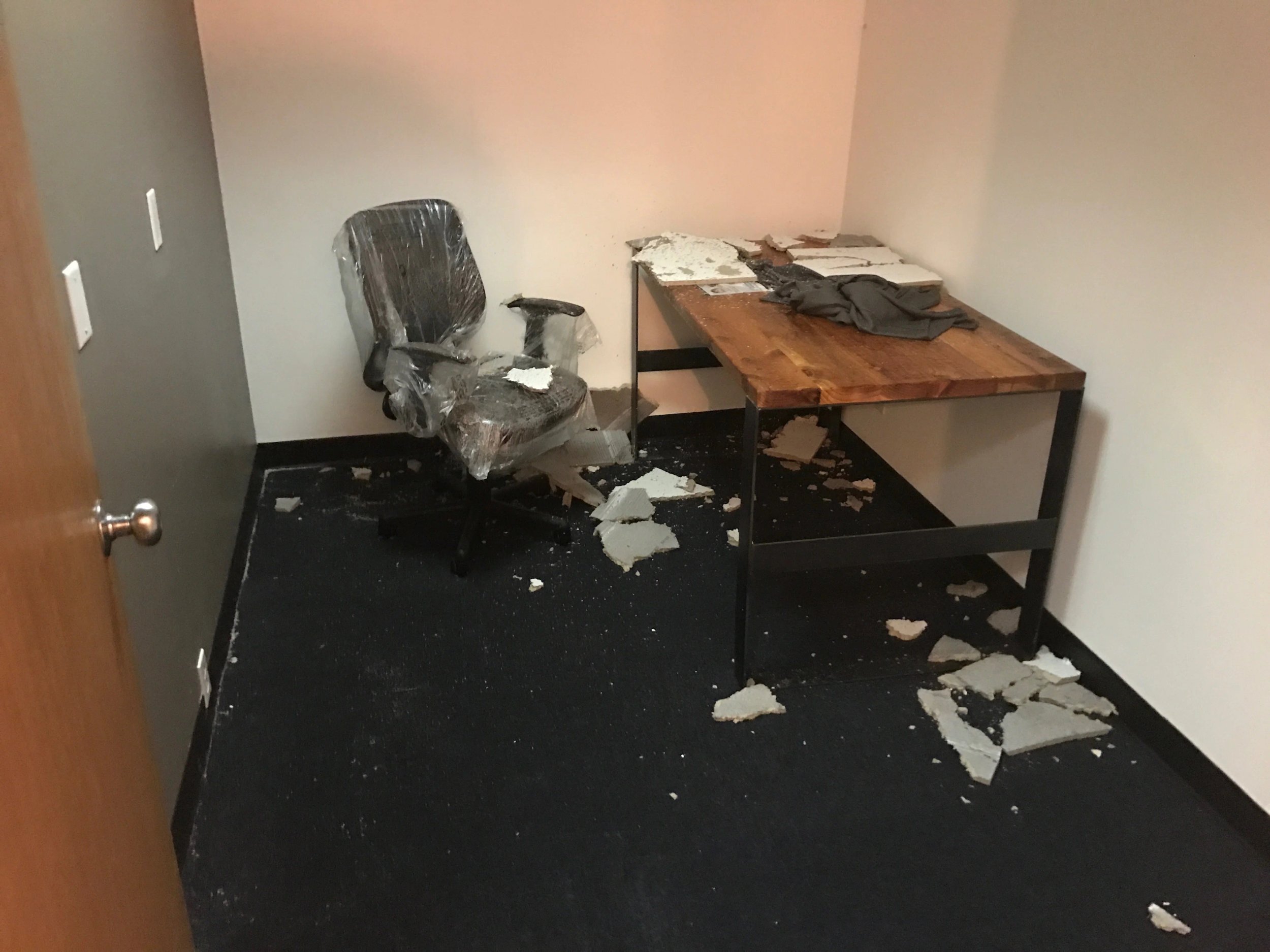 Messy office with broken debris and overturned chair