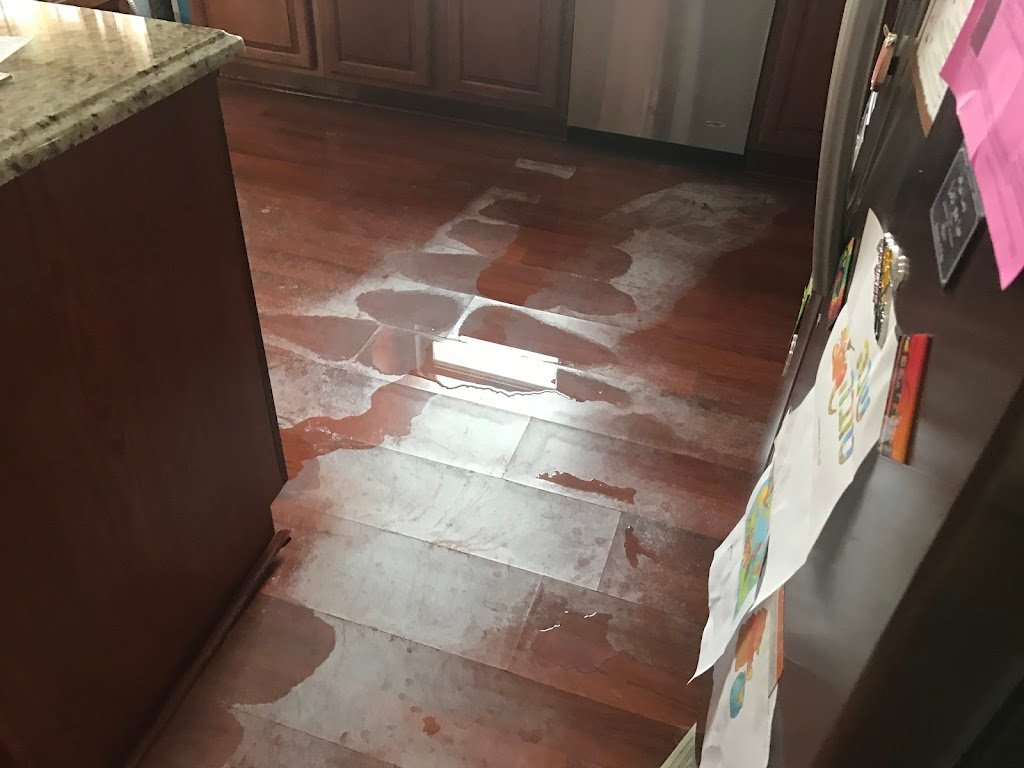 Water damage on wooden kitchen floor